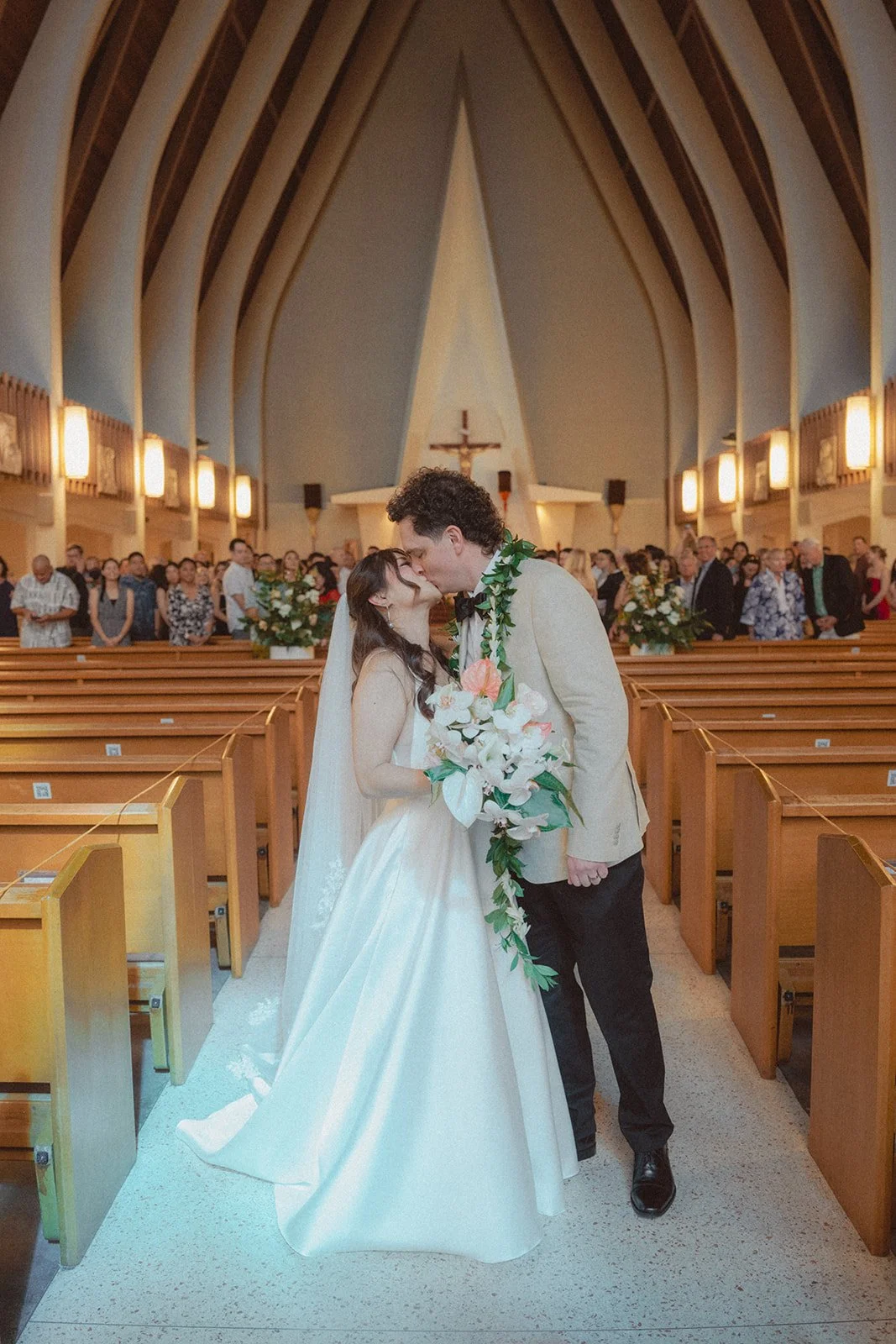 bride and groom kissing in church