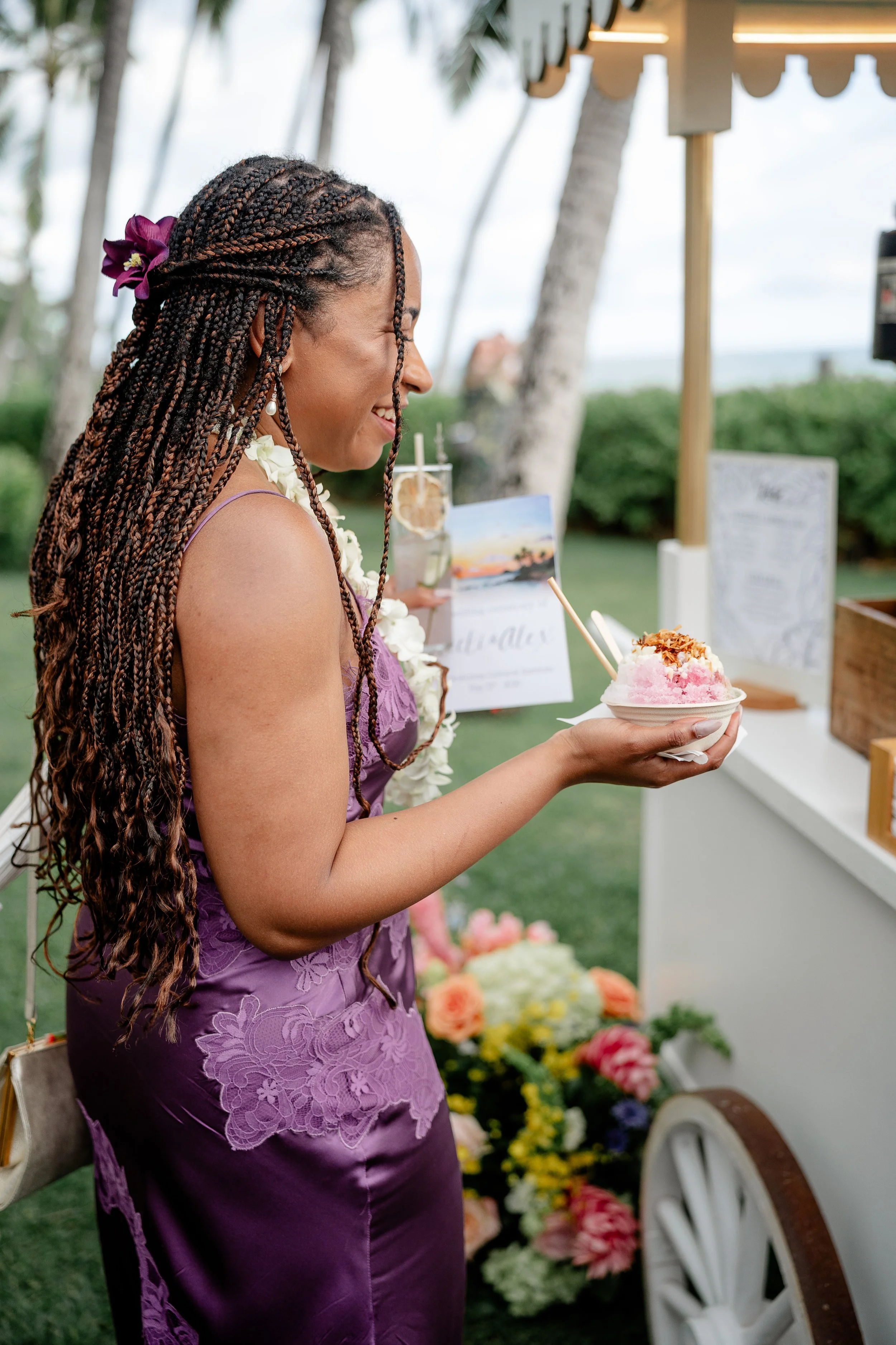 a female guest smiling and holding shaved ice