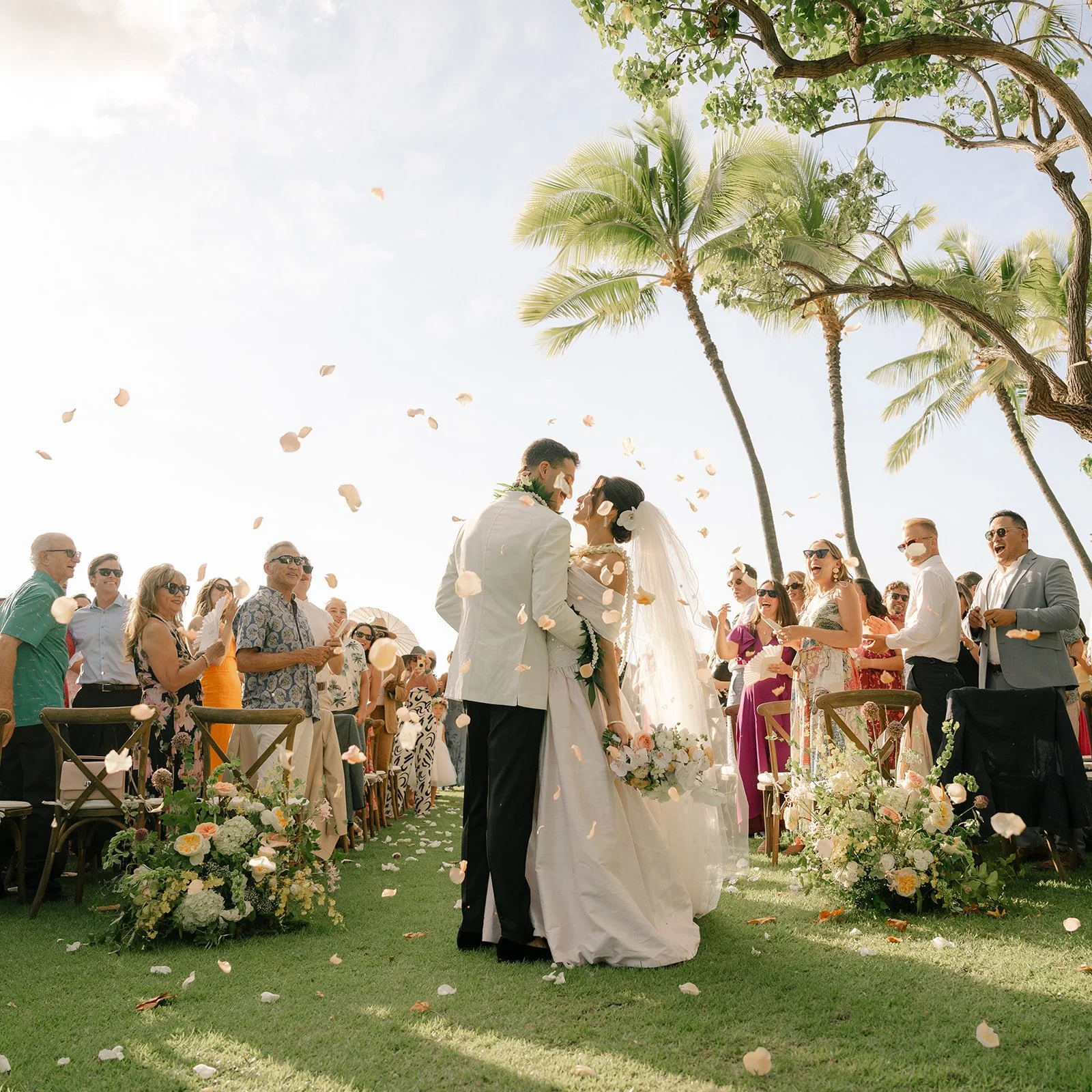 bride and groom with flower petals in the air