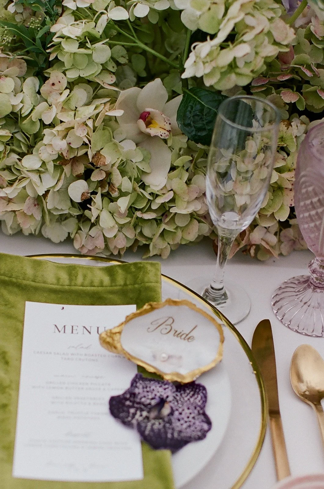 Oahu wedding planner Love Letter Weddings styled this place setting with oyster place card, purple orchid, and dinner menu at Paliku Gardens