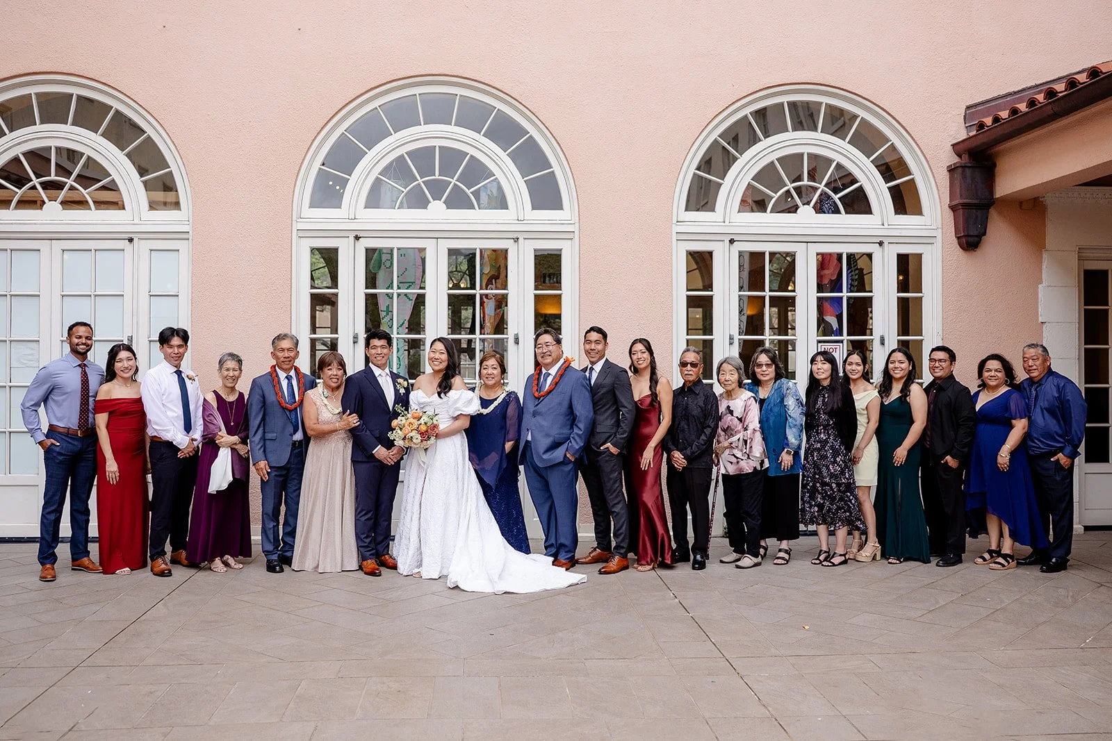 bride and groom with their family at capitol modern museum in hawaii