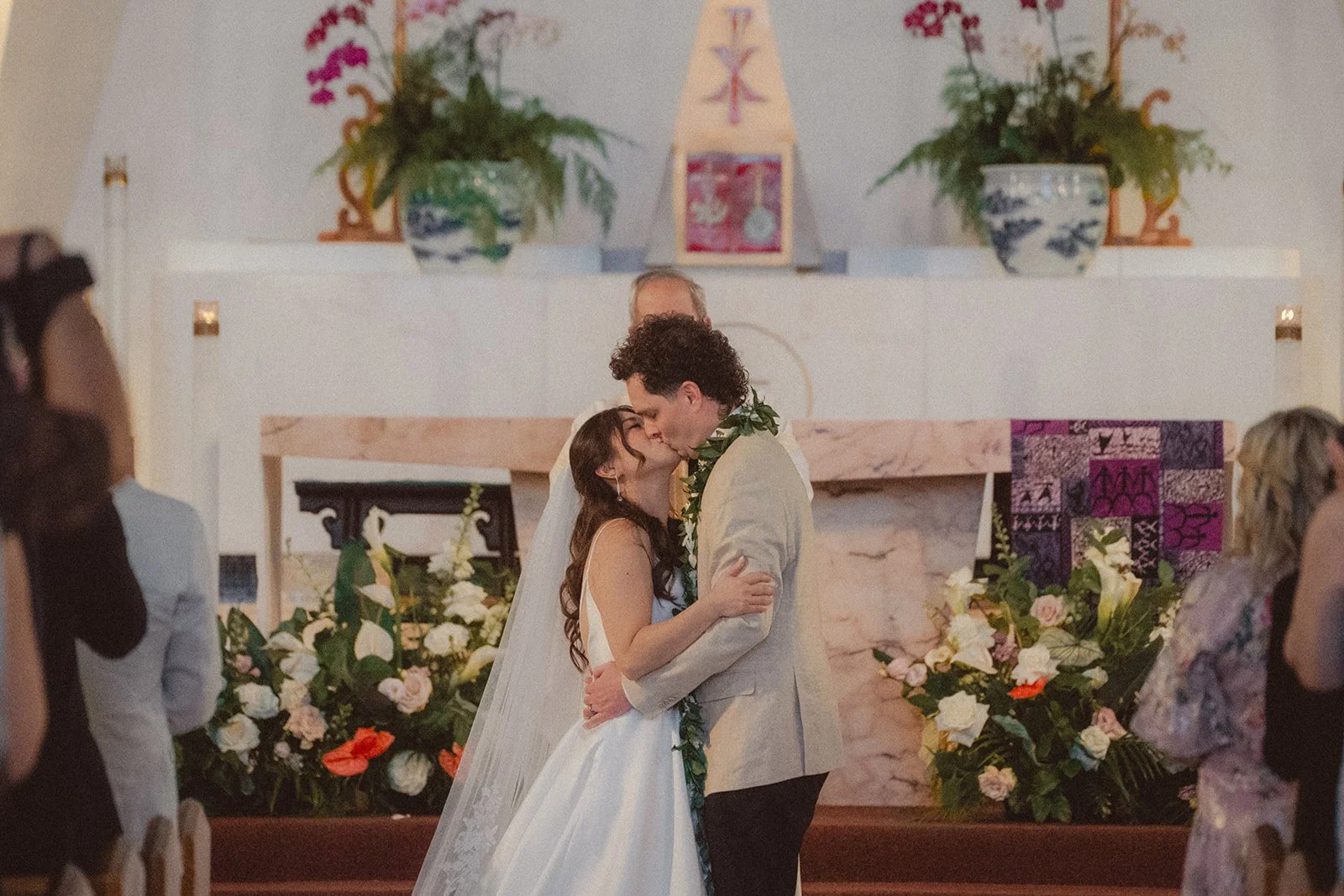bride and groom kissing during ceremony