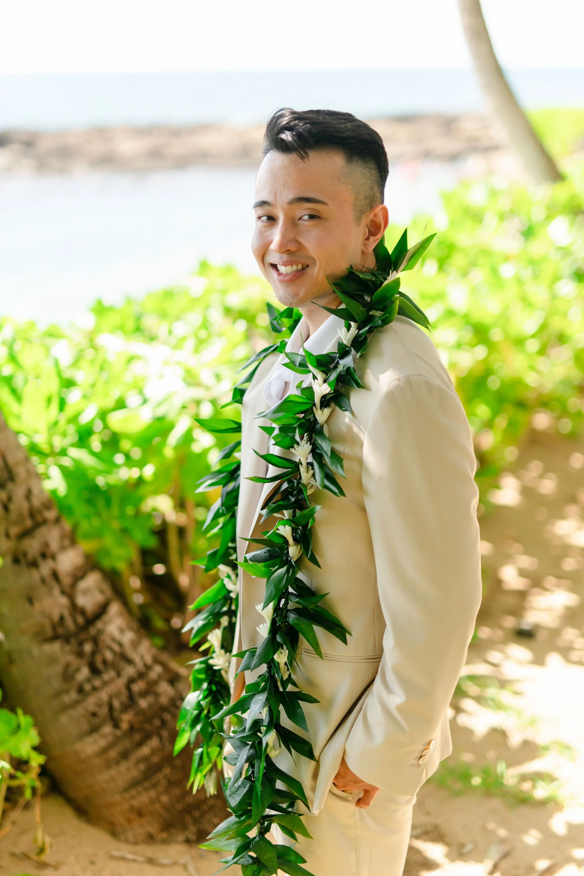 groom by beach in Hawaii