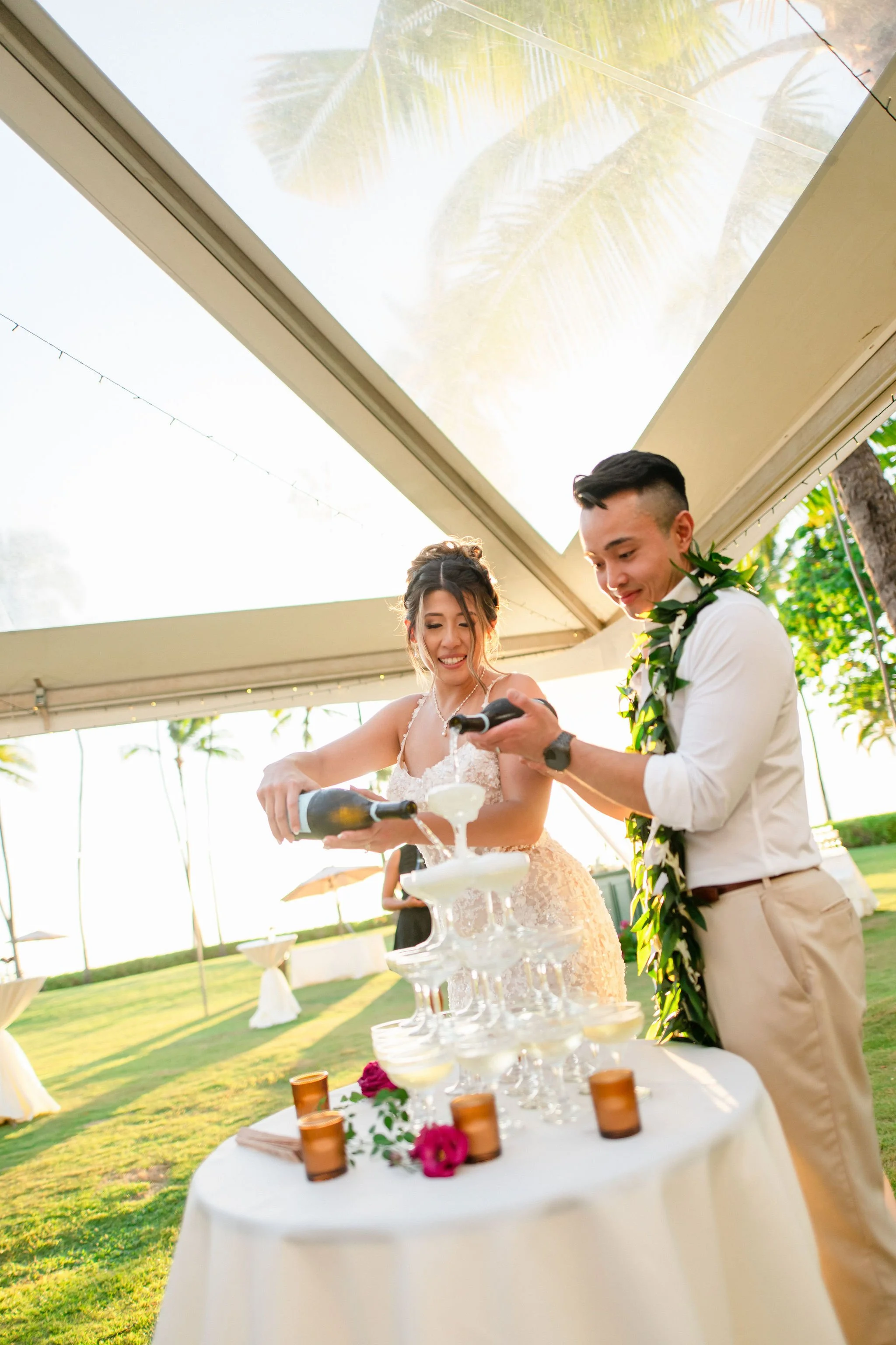 bride and groom pouring champagne tower