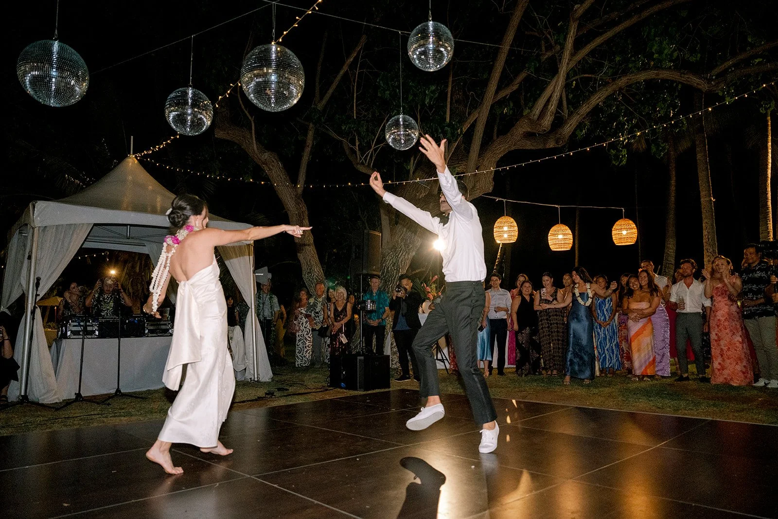 bride and groom dancing under disco balls