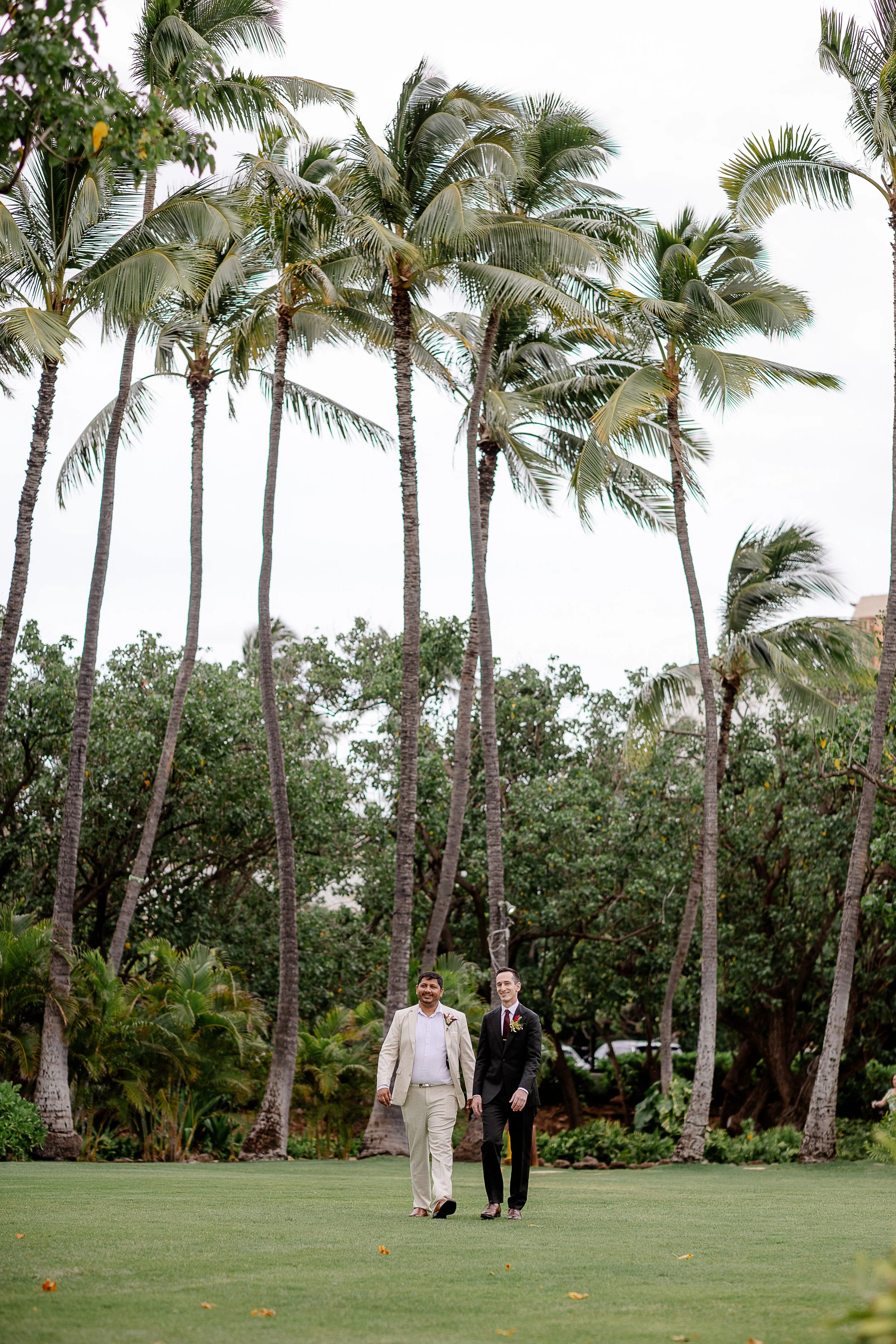 groom walking down aisle in Hawai'i with groomsmen