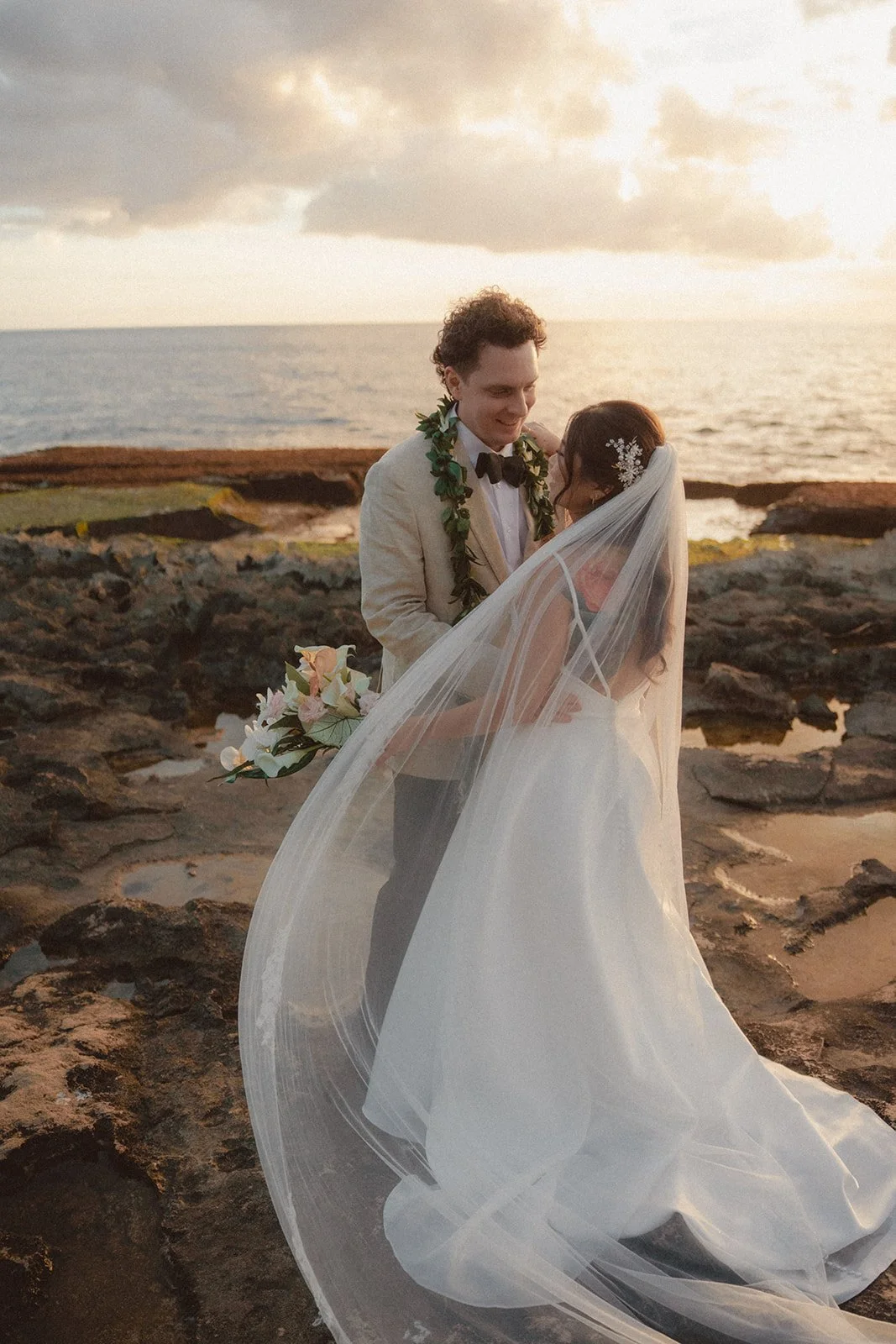 bride and groom on beach in hawaii