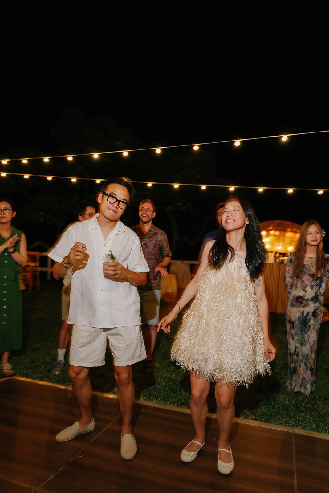 Bride and groom in the middle of the dance floor joining guests for the game