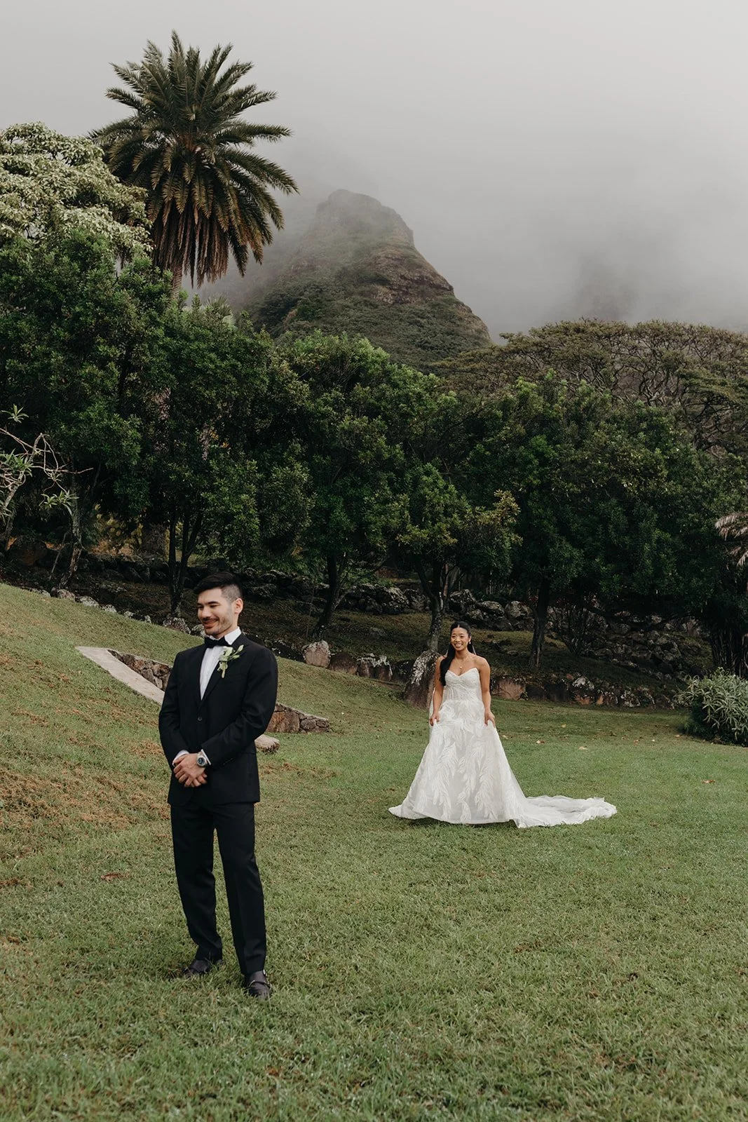 bride and groom doing first look in front of mountains in hawaii