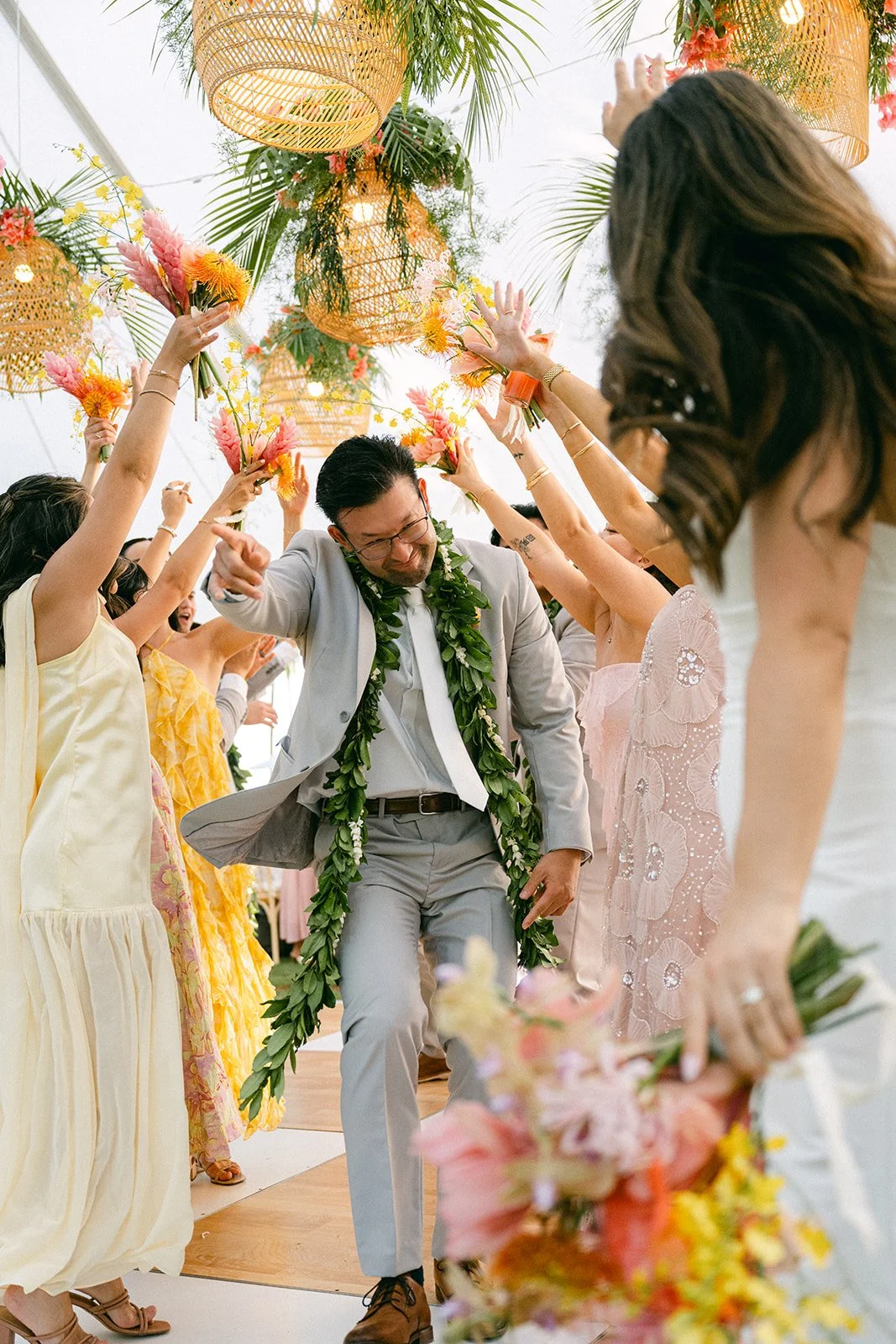 groom walking tunnel made by wedding party