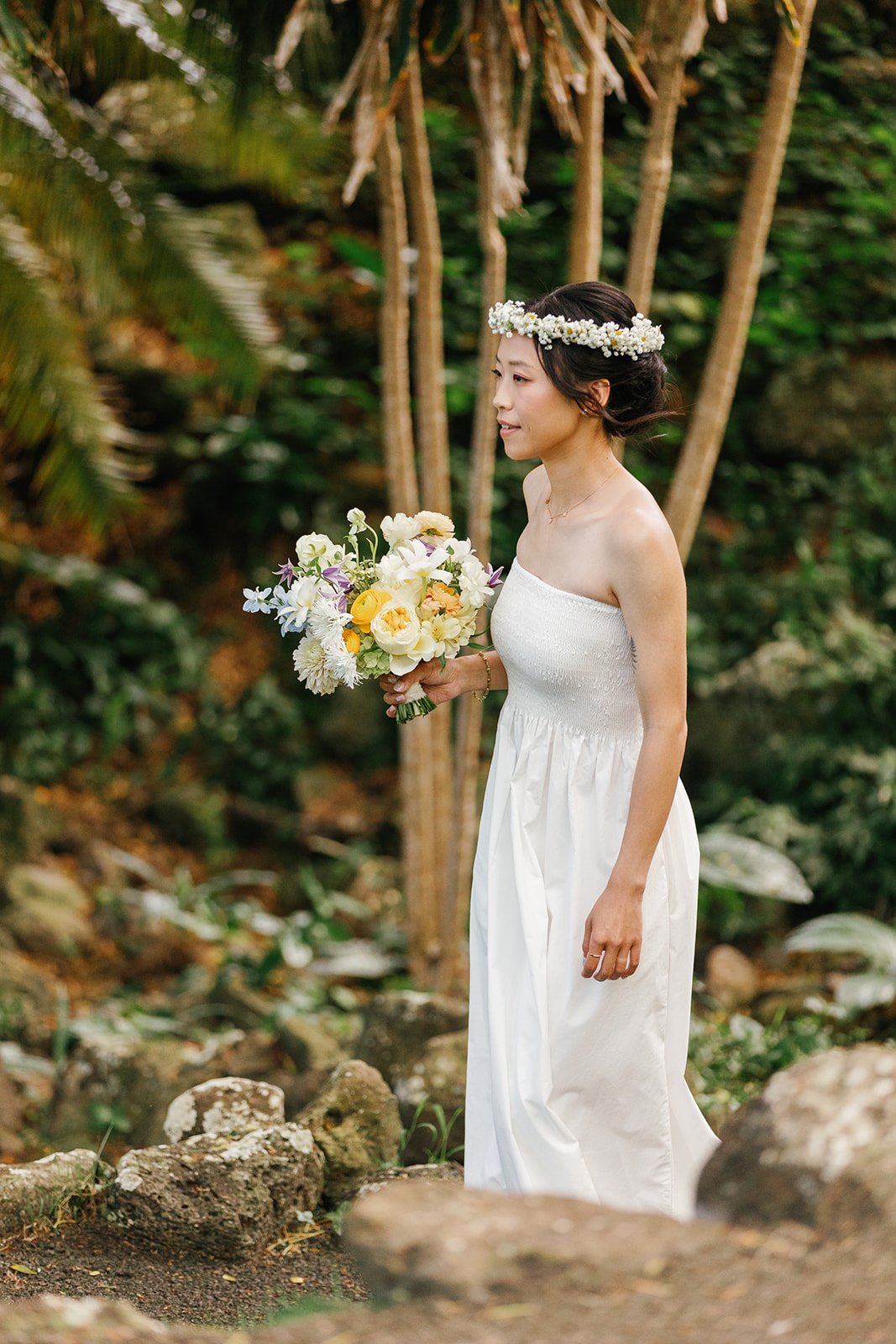 Bride in her wedding dress wearing a flower crown and holding her bouquet