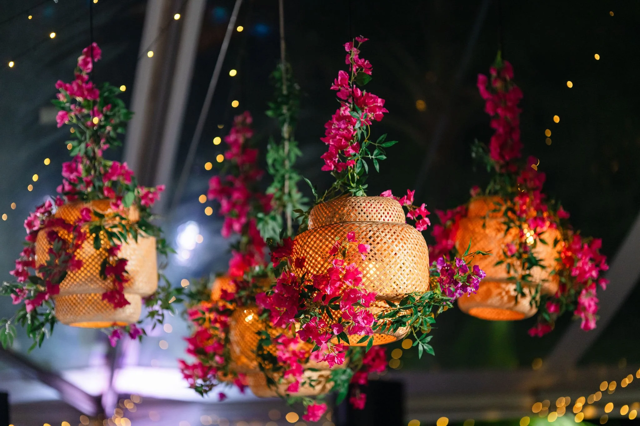 pink flowers around rattan lantern