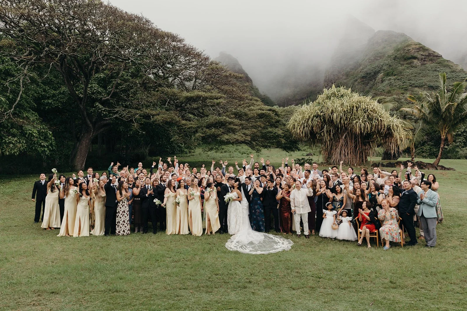 bride and groom with all their wedding guests in hawaii