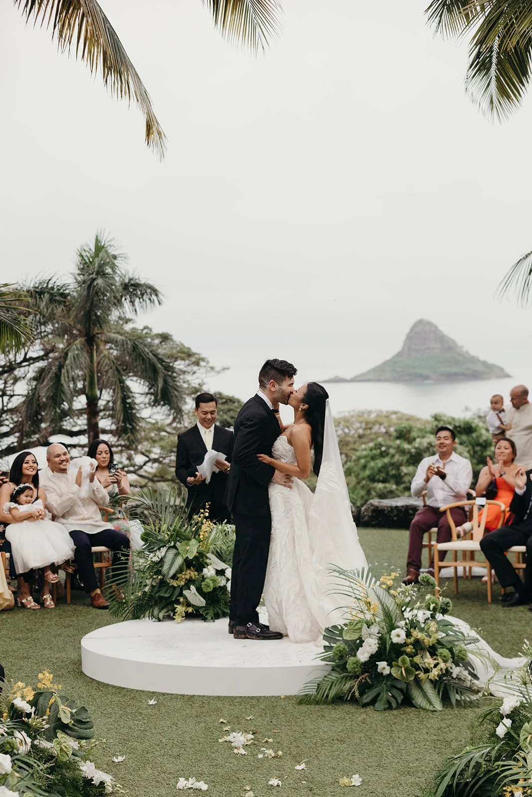 bride and groom kissing during wedding ceremony in hawaii