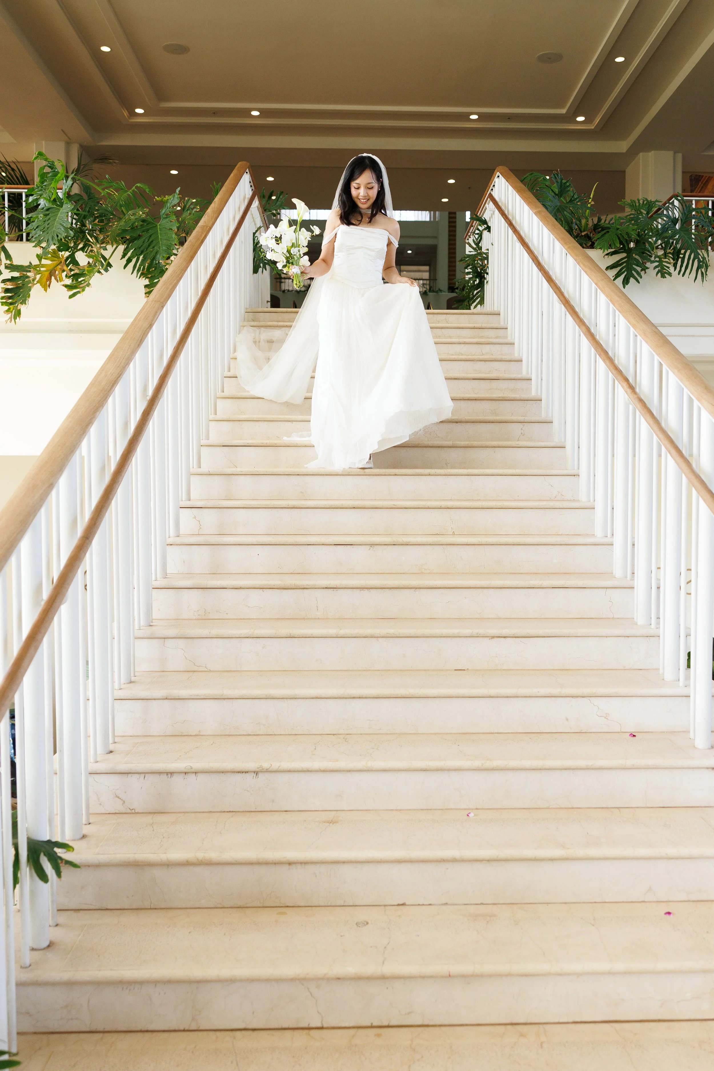 bride heading down staircase to meet groom got the first look