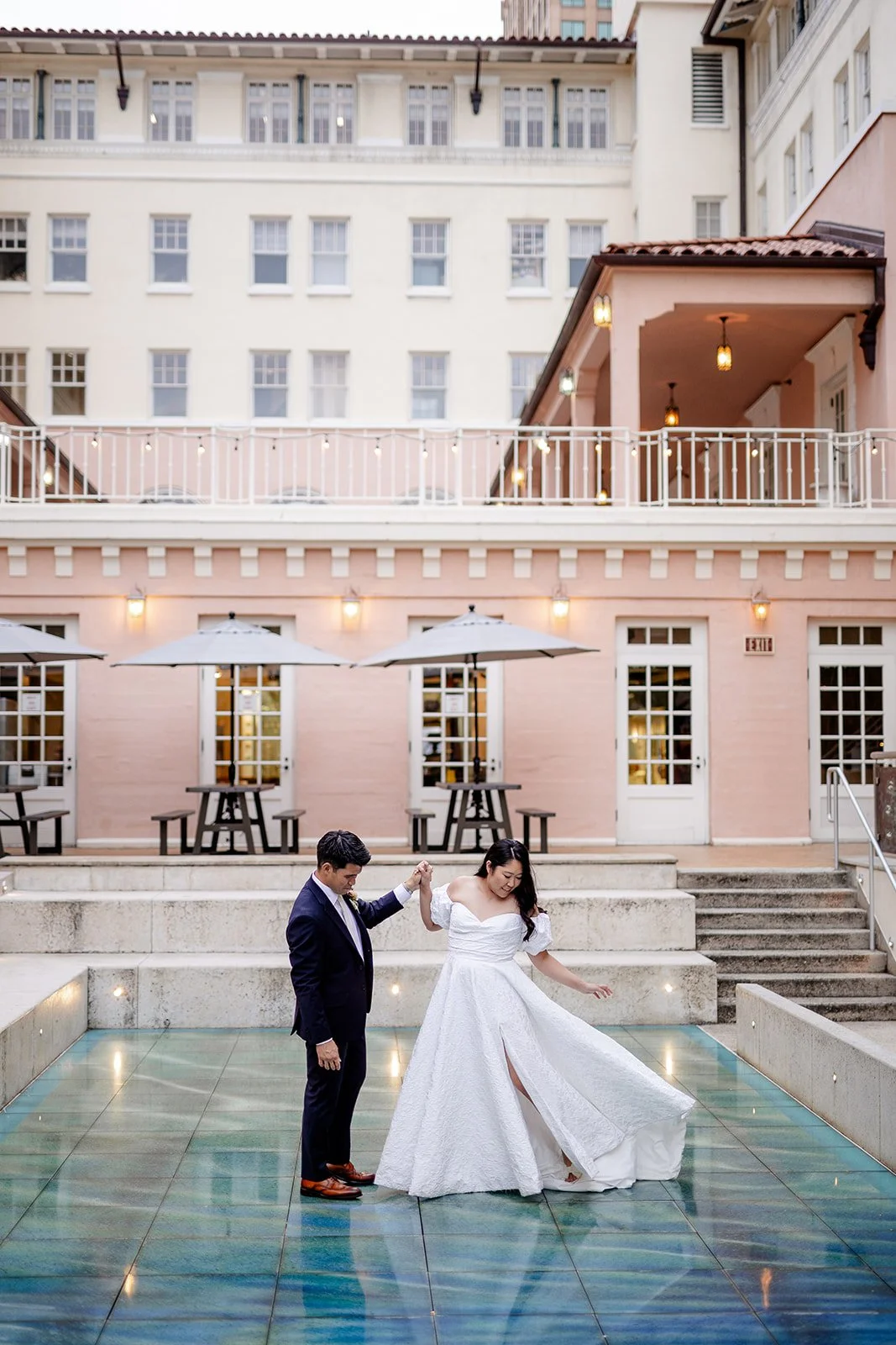 bride and groom dancing in sculpture garden at capitol modern museum in hawaii