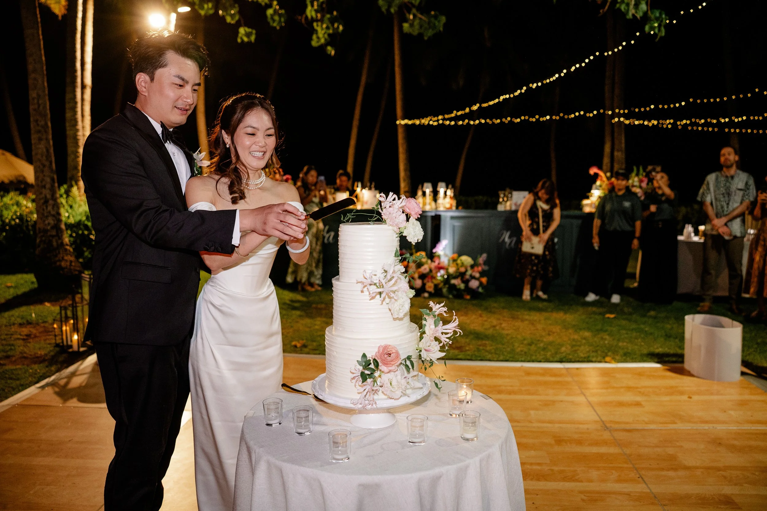 bride and groom cutting into wedding cake