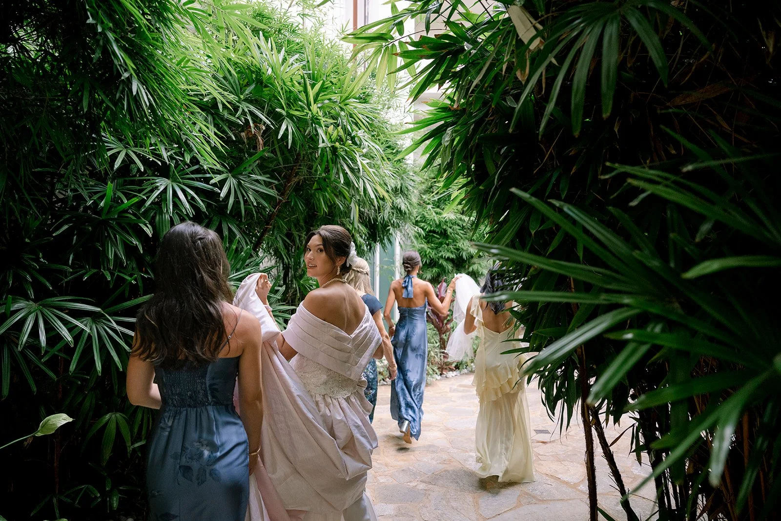 bridesmaids helping bride walk