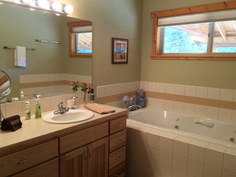 Full bath with jetted tub and shower.