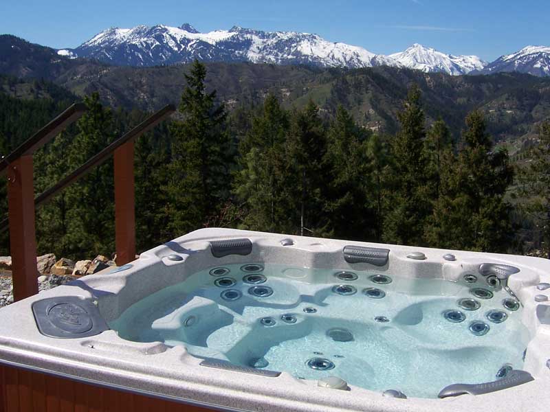 Outdoor hot tub with a view of the mountains.