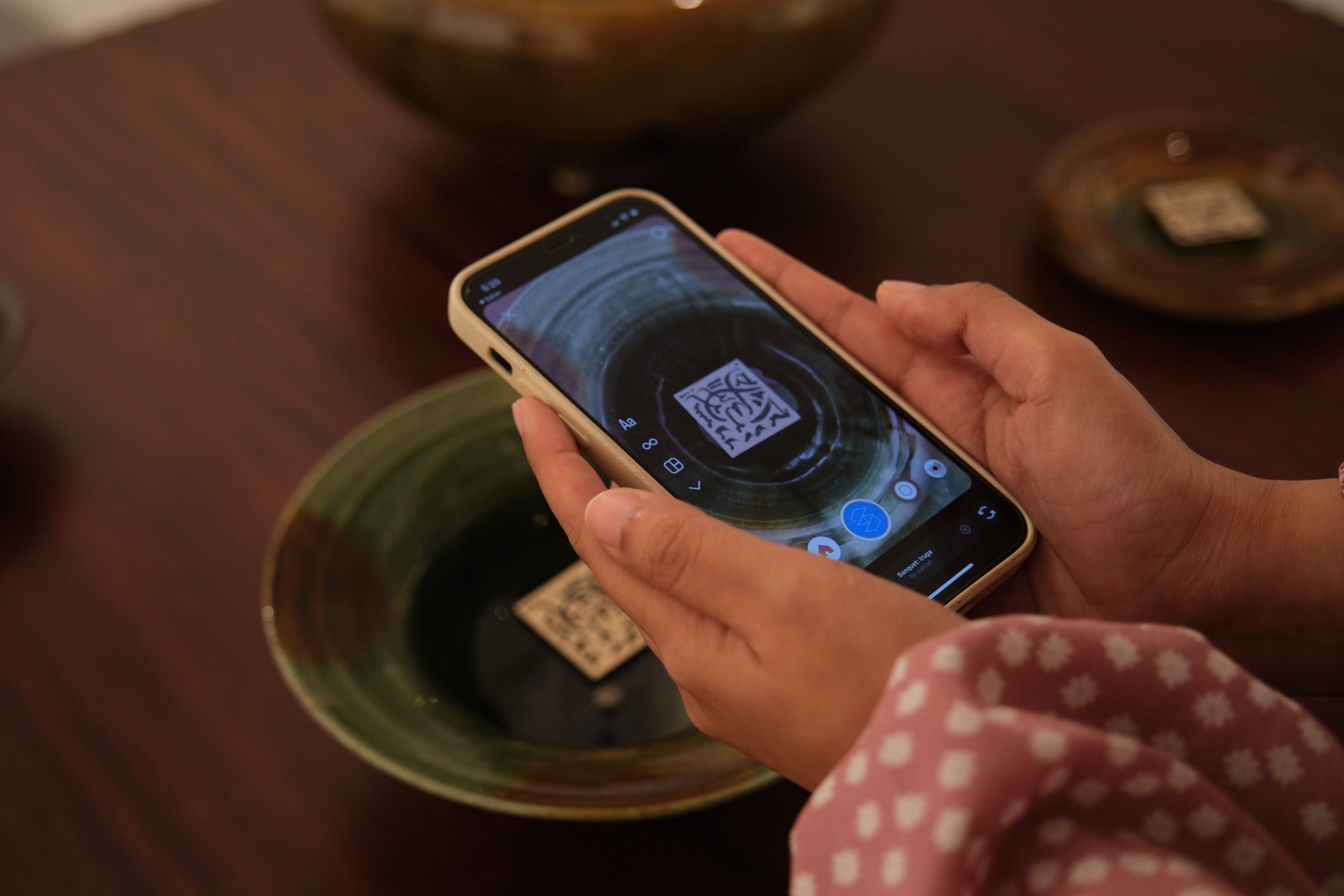  Scanning the custom QR code to trigger the AR (augmented reality) visuals Photo by  Art Outreach Singapore  