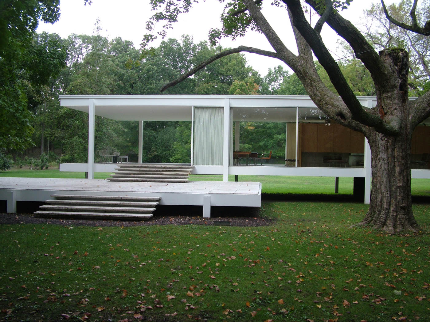 Farnsworth House by Mies van der Rohe has glass walls with a timber core for living, full length curtains for privacy.