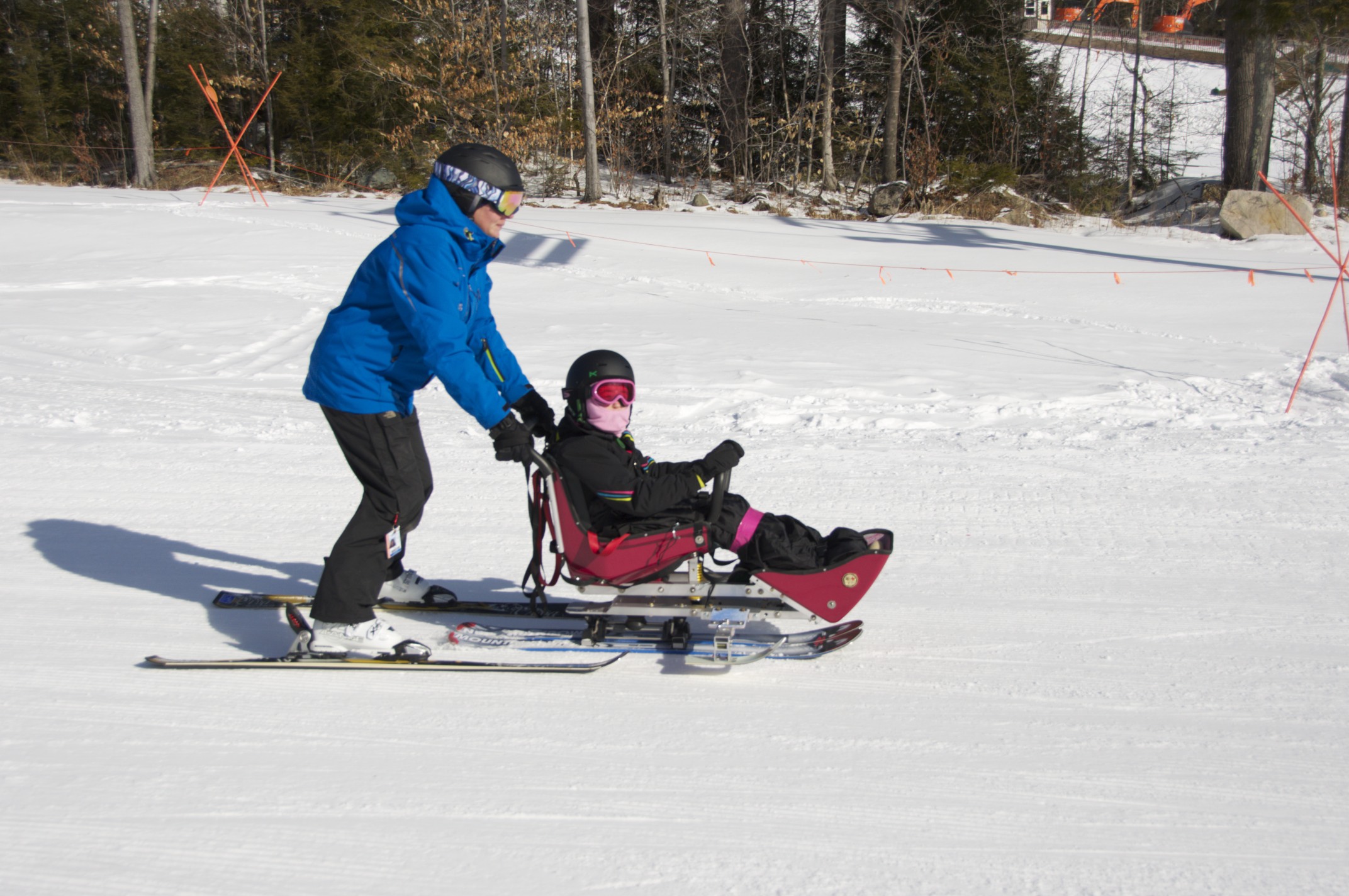 Paige Davis guides a bis-ski student back to the lift.