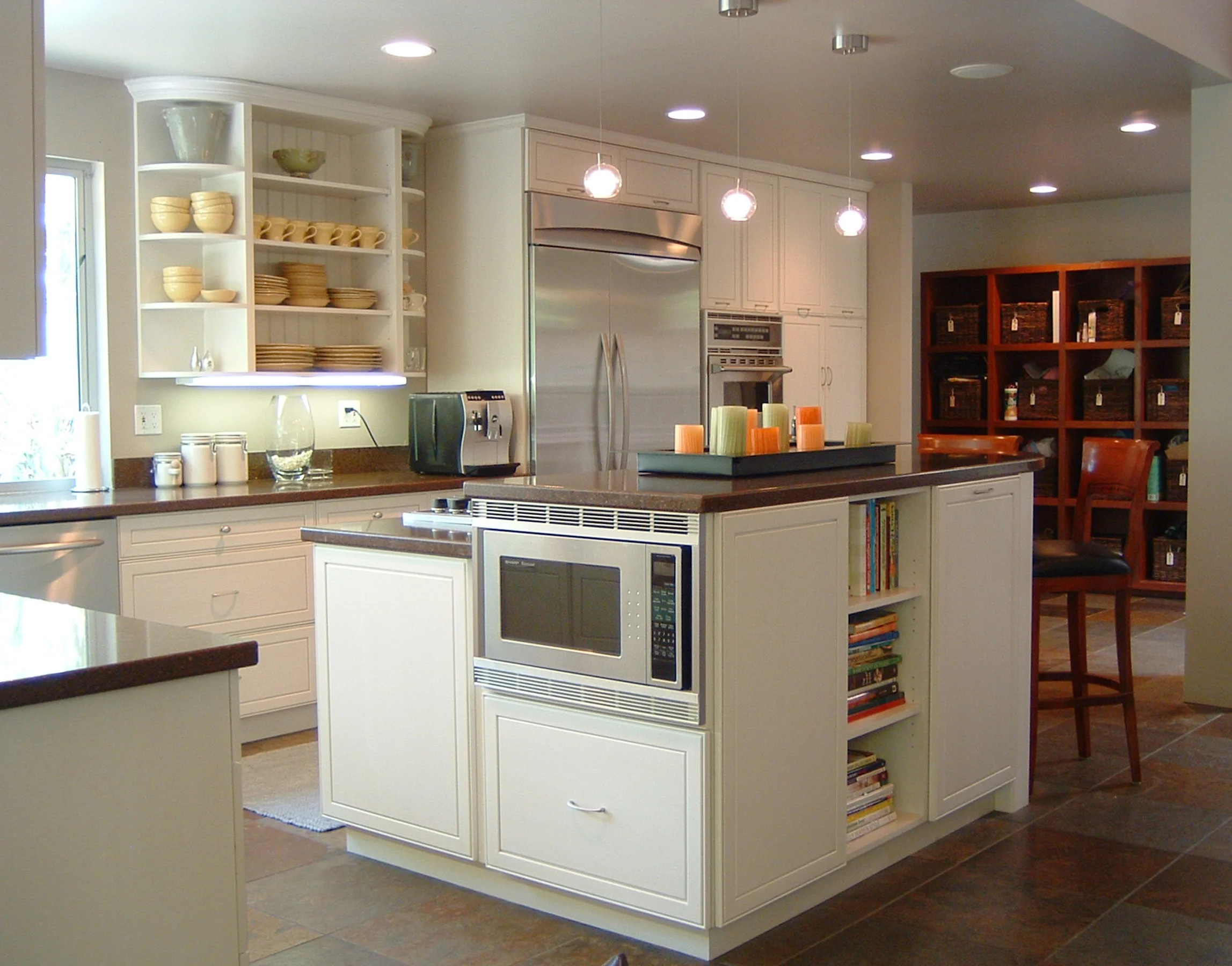 A modern yet warm and inviting kitchen. The island is a workhorse; lots of storage, range top, microwave, and seating space too! 