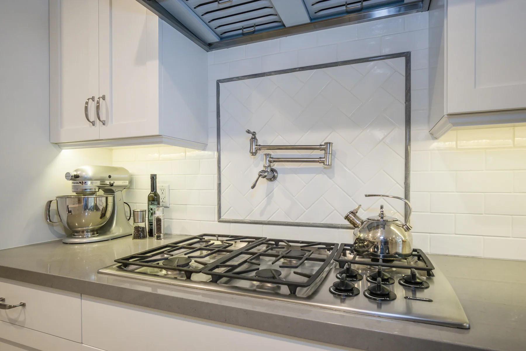 As this is a galley kitchen, we added a pot filler at the cooktop saving steps to the sink.
