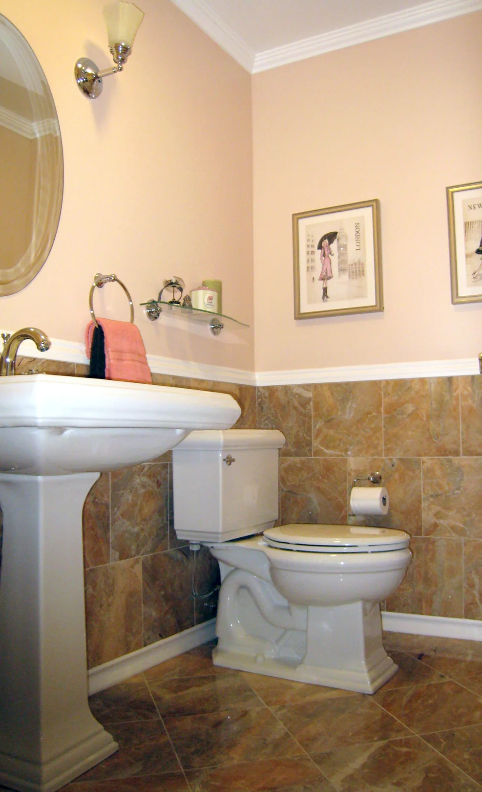 A sweet little powder room. The pink is toned down with the neutral marble wainscot.