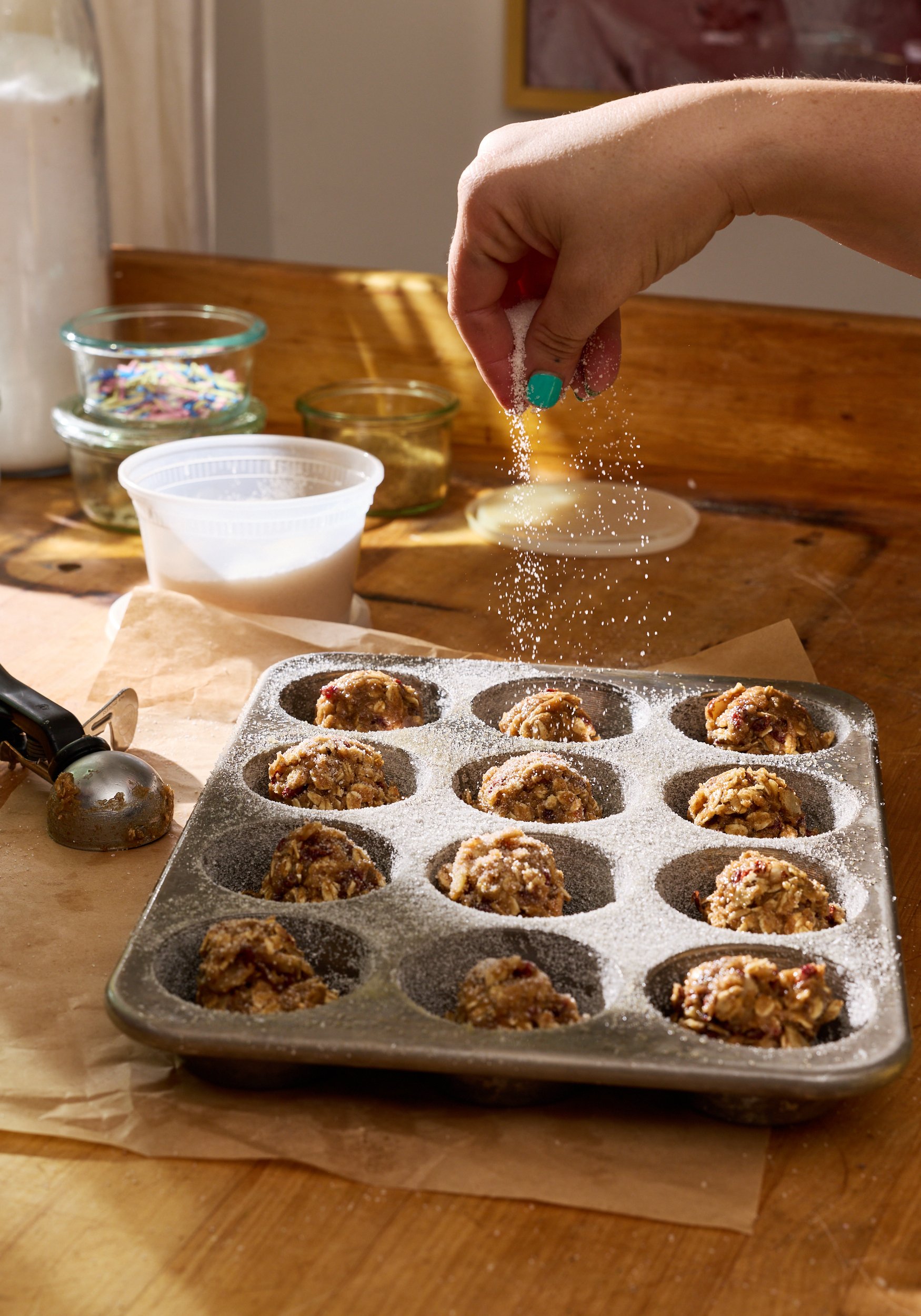 Hand Sprinkling Sugar over Muffin Tins / Jennifer Chong Lifestyle Photographer Los Angeles