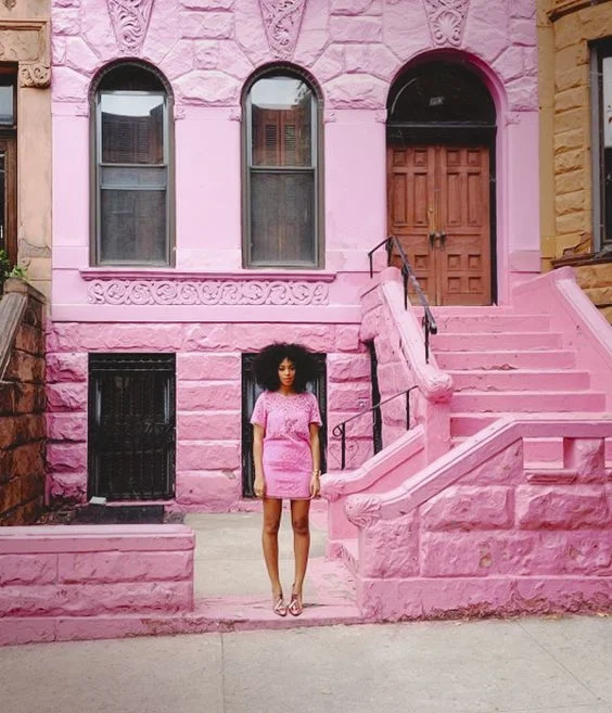 Solange in a cool, neon pink. Image via Eff Yeah Solange .