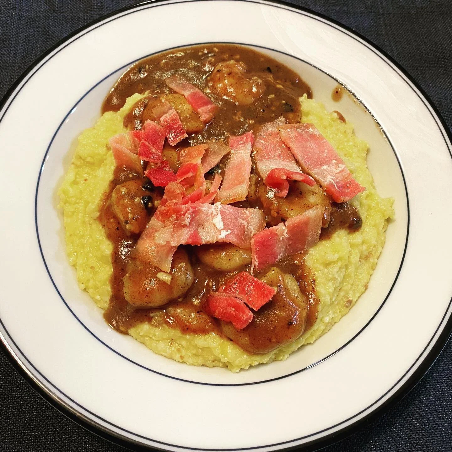 Yet another meal inspired by places I miss and travel cancellations. Tonight is Low Country Shrimp &amp; Grits topped with bacon. I had phenomenal meal of S &amp; G at @churchillssav that was equally delicious and I can&rsquo;t wait to visit again so