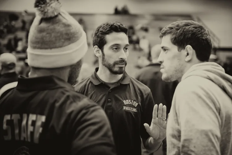BYW President José E. Valenzuela (pictured center) huddles with his staff during a tournament (photo credit: Jared Charney)