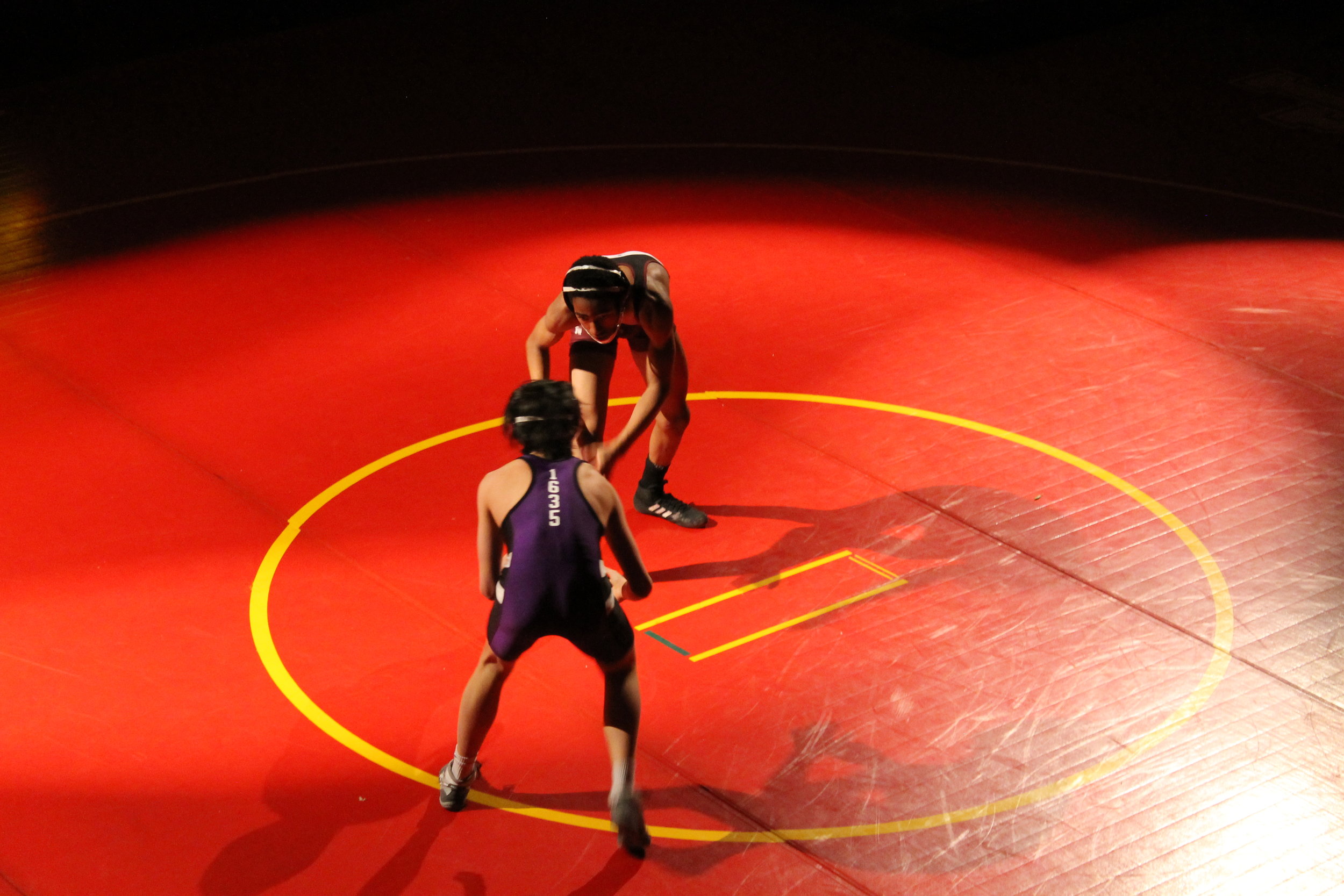 Damari Green (JQUS) and Jimmy Sullivan (BLS) compete under the lights at Josiah Quincy Upper School in Chinatown.