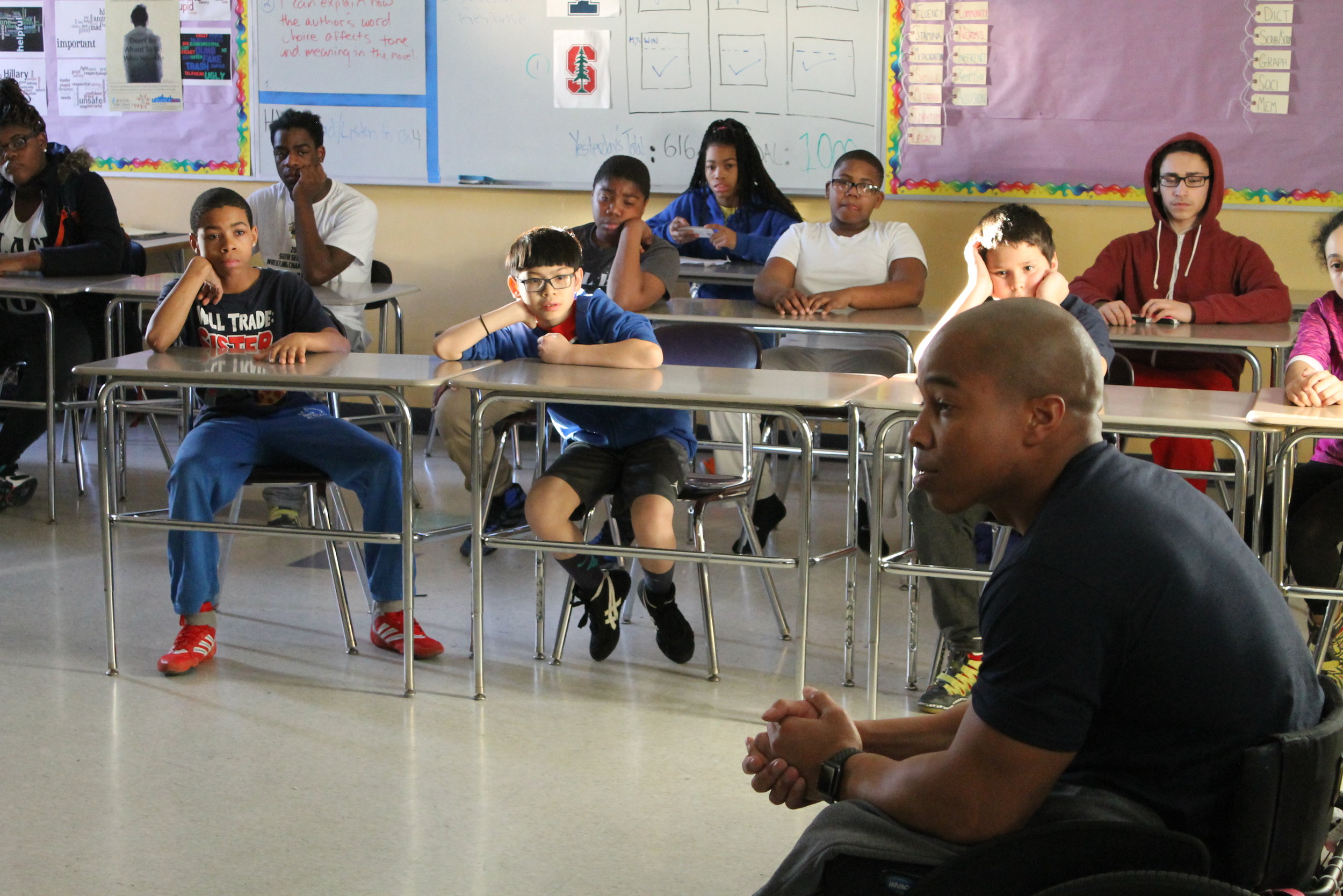 Rohan Murphy speaks to a classroom of BYW student-athletes at the Lilla G Frederick Middle School in Dorchester, MA.