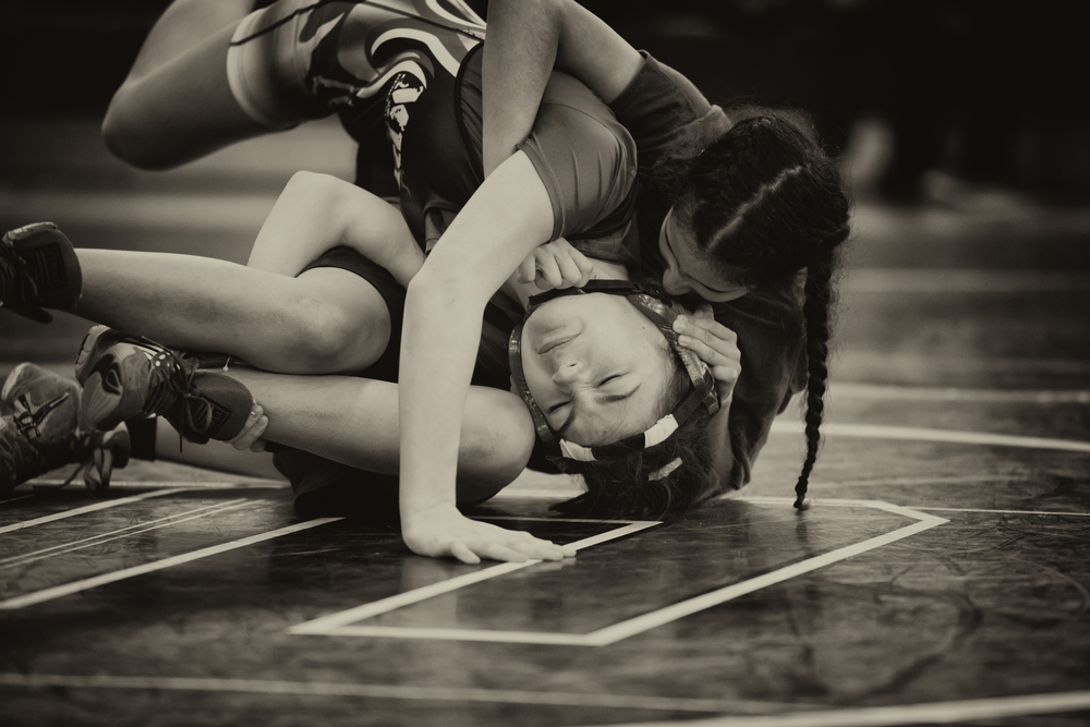 Vanessa Rico (right), a student of East Boston High School and participant in Boston Youth Wrestling, at a February 2016 competition. Photograph: Jared Charney