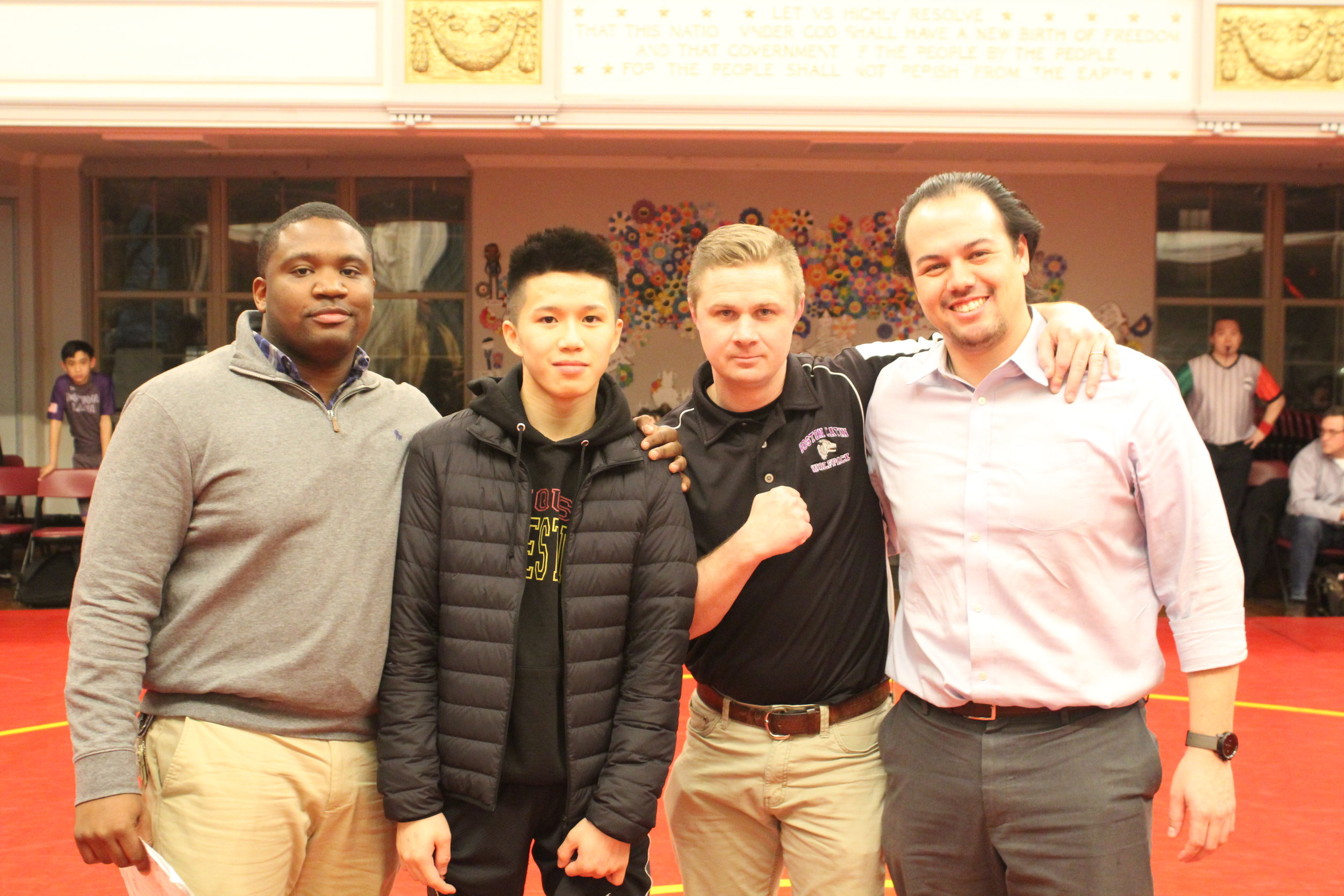 Ricky Sun was awarded the “True Grit Award” given annually to the wrestler who displays the grit exemplified by Huang Wei Speicher. Pictured with Ricky are Coach McKoy (JQUS), Coach Gibbons (BLS), and Josh Speicher.