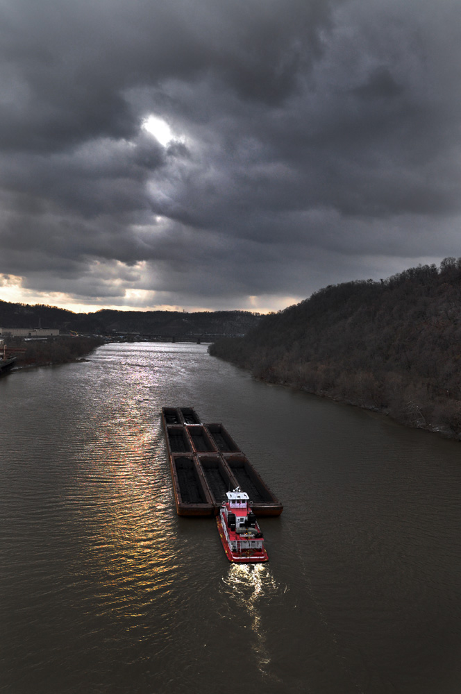  Coal barge, Monongahela River. Coal barges such as this one, just east of Hazelwood, are a common sight on the Mon. Diesel fumes from road, rail and river traffic are a major source of air pollution in the river valleys of Western Pennsylvania.   
 