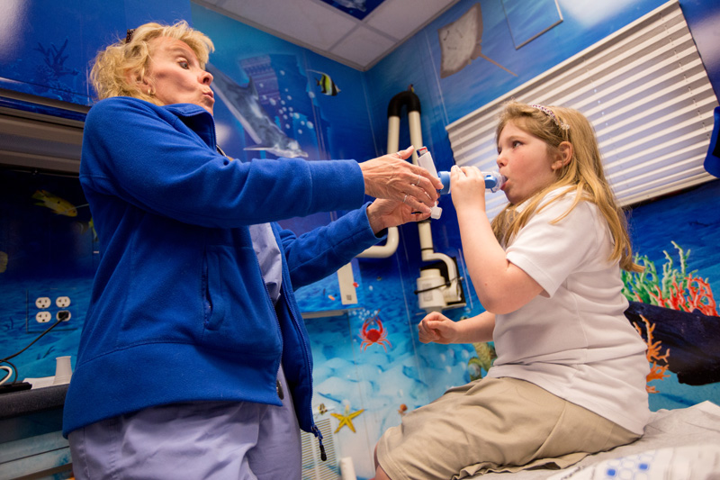  Rose Lanzo (left), a research coordinator at Children’s Hospital of Pittsburgh of UPMC gives Alivia Thomas a refresher on how to use her inhaler and spacer in the Ronald McDonald Care Mobile. The Care Mobile makes it easier for the patients by bring