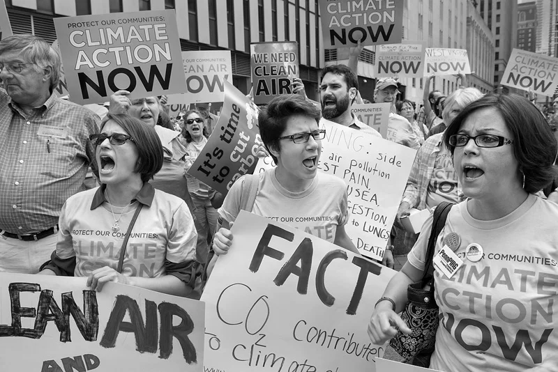 Supporters of EPA regulations against power plant carbon emissions rally in front of theAugust Wilson Center in Downtown Pittsburgh on Thursday, July 31, 2014. About 300 environmental activists yell their support for stricter pollution rules proposed by the Environmental Protection Agency during a march to the Pittsburgh Federal Building by about 5,000 people, led by the United Mine Workers of America, during a two-day public hearing being held by the EPA.. © Scott Goldsmith/TDW 2014