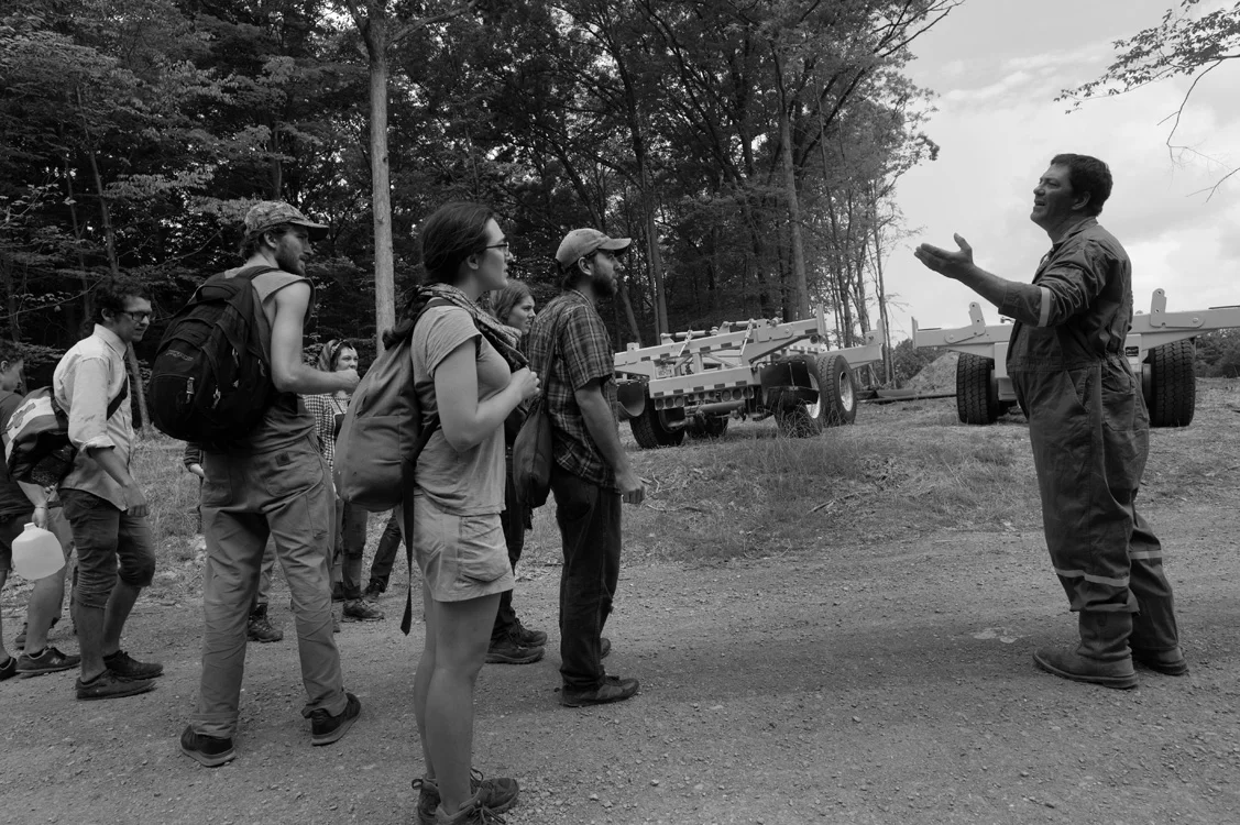Activists and a gas rig worker meet at the edge of a gas-drilling operation in Moshannon State Forest where drilling from one rig radiated out in eleven different directions. © Lynn Johnson/MSDP 2012