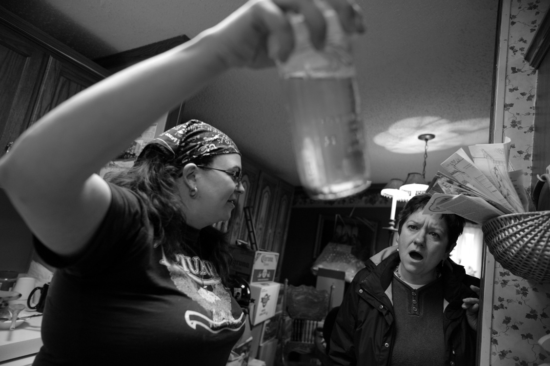  Kim McEvoy shows Carrie Hahn the contaminated water that the DEP has proclaimed "safe" to drink after Rex Energy began gas exploration in their area outside Evans City. Both women became activists out of frustration and anger when, they felt, both l