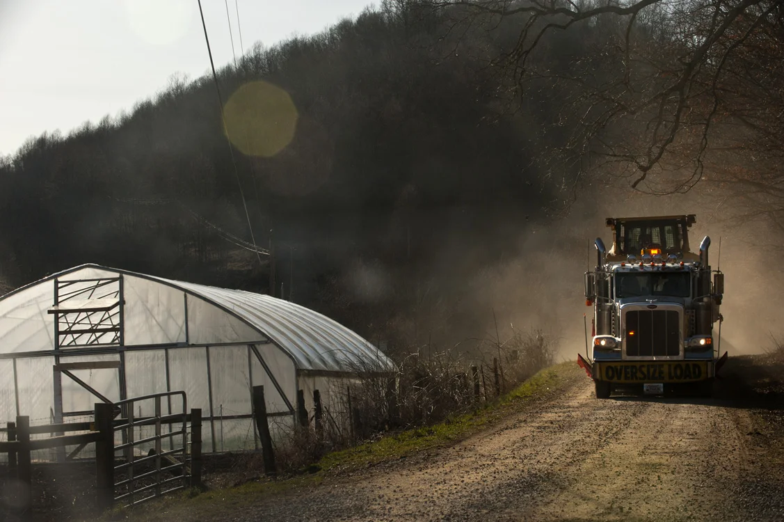 A large truck rumbles by the Williams' farm. Dust is another problem for landowners because of increased truck traffic on rural roads. © Martha Rial/MSDP 2012