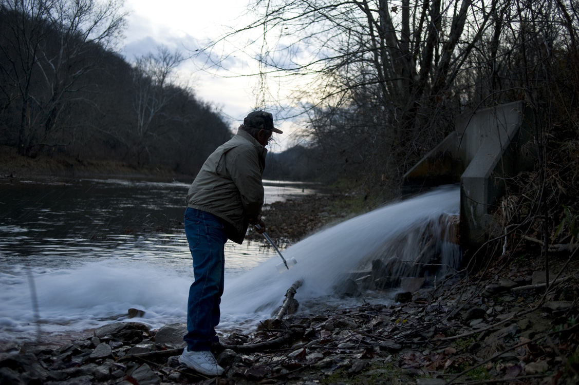  Ken Dufalla collects a water sample while monitoring bromide levels at Clyde Mine discharge along Ten Mile Creek in Greene County. In fresh water, elevated levels of bromide, a substance usually found in seawater, are always a result of human activi