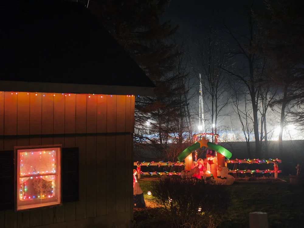 Bright lights illuminate a Hallburton fracking site situated next to the leaseholder's home which is decorated with Christmas lights. Franklin Forks, Susquehanna County, 2011. © Nina Berman/MSDP 2011