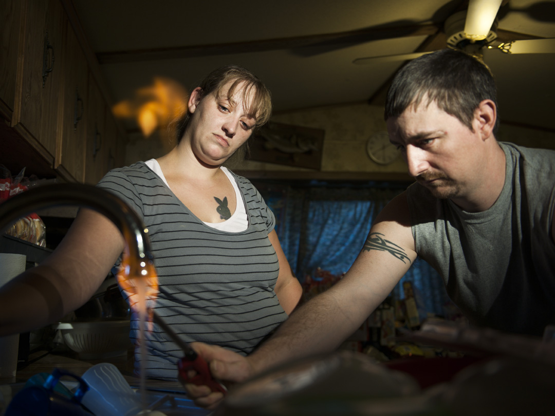  Jodie Simons and Jason Lamphere demonstrate how their tap water ignites. They have lived since 2010 without well water to drink or bathe in, attributing it to Chesapeake's nearby gas-drilling activities. Monroeton, Bradford County 2011.&nbsp; ©  &nb