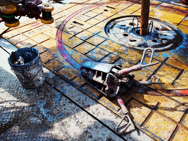  The hole in the middle of this drilling rig platform (yellow area) is where the drill is inserted. Extension pipes are attached as they add length to achieve a depth of about a mile. Most of the extension pipes are rusted and corroded from the caust