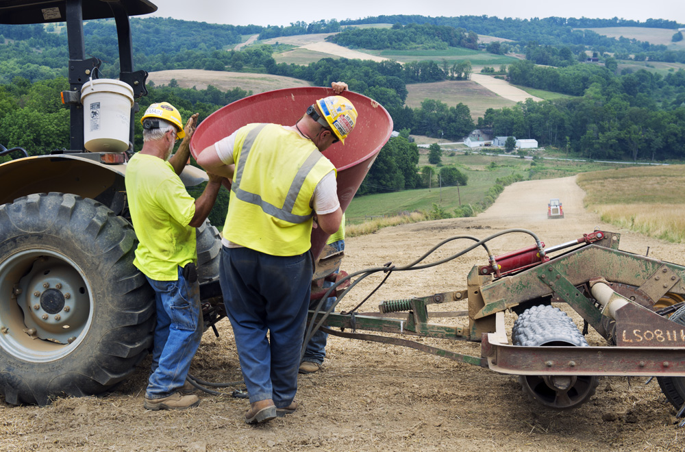  An underground pipeline stretches like a ribbon into the distance. Workers ready the top of the pipeline to plant grass as the final phase of the pipeline built to transport the gas harvested from the Marcellus Shale. Mt Pleasant Township, PA. This 