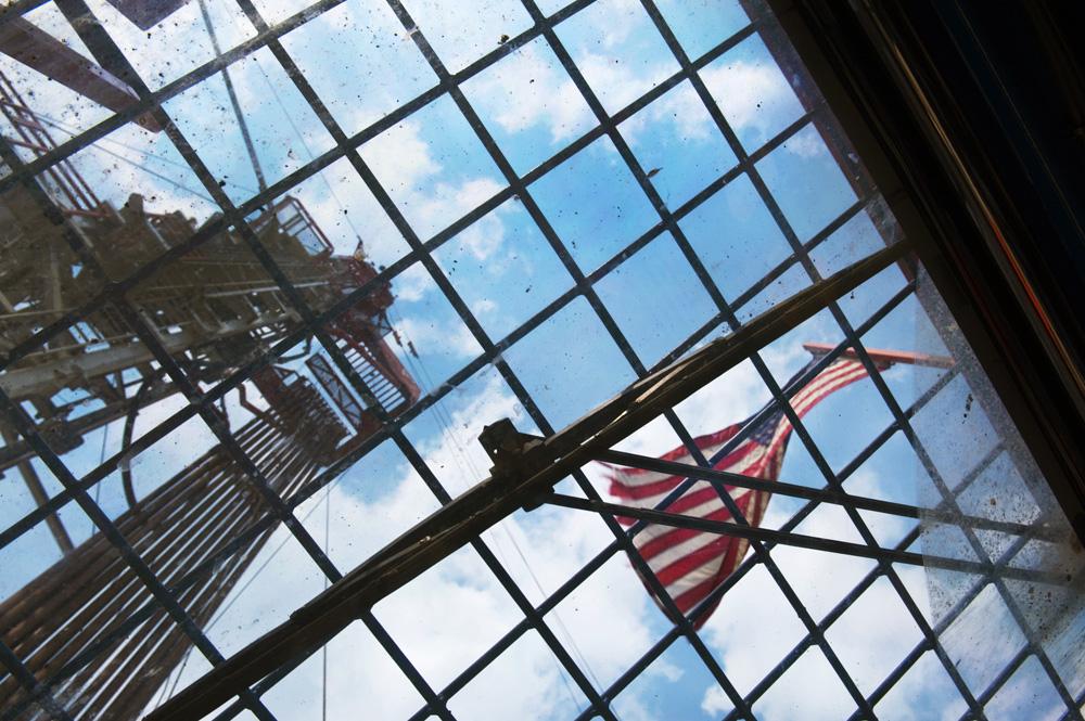  Looking up at a natural-gas drilling rig in Washington County, PA, through a ceiling window of the control room on the drilling platform. The flag is used to help the people working on the rig determine which way the wind is blowing, to help avoid a